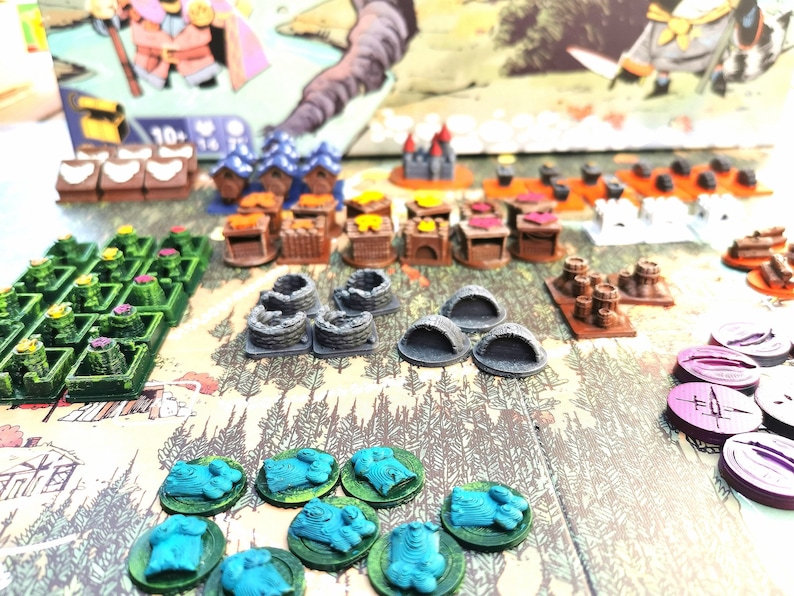 May include: A game board with various colorful game pieces, including small houses, trees, and tokens. The board is made of wood and has a brown background. The game pieces are made of plastic and are in various colors, including green, blue, red, and yellow.