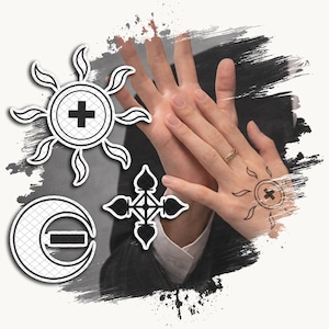 May include: A graphic design featuring a sun symbol with a plus sign, a crescent moon symbol with a minus sign, and a four-pointed cross symbol. A gold ring is visible on a finger, and a sun symbol with a plus sign is displayed on the back of a hand.