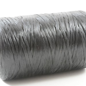 May include: A spool of dark gray raffia ribbon. The ribbon is tightly wound around a cardboard core. The raffia has a slightly textured appearance and a matte finish. Ideal for crafting and gift wrapping.