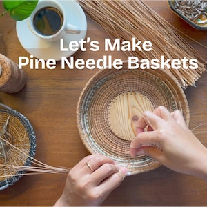 May include: A round pine needle basket in progress with a light wood base, featuring the text Let's Make Pine Needle Baskets. The scene includes a spool of thread, a small bowl with scissors, and a bundle of pine needles on a wooden surface.
