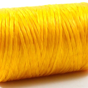 May include: A spool of bright yellow raffia ribbon. The ribbon is tightly wound around a cardboard core. The raffia has a textured, woven appearance. Ideal for crafting, gift wrapping, and decorative purposes.