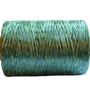 May include: A spool of green and blue raffia ribbon. The raffia is tightly wound around a wooden core. The color transitions from a light green to a darker blue-green hue. The raffia has a textured, woven appearance.