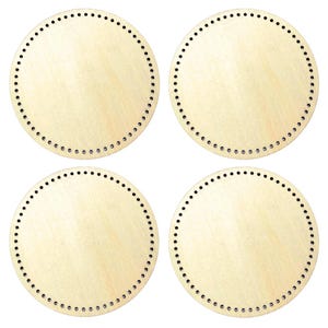 May include: Four round wooden bases with evenly spaced holes around the perimeter. The bases are a light, natural wood color, and the holes are small and black. These bases are likely for crafting or basket weaving.