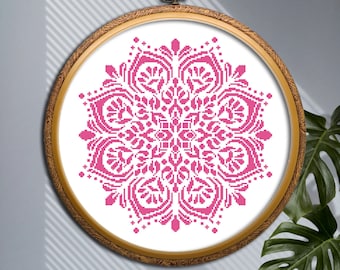 May include: A pink mandala cross-stitch pattern in a wooden embroidery hoop.