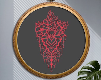 May include: A framed embroidery hoop featuring a red floral design on a dark grey background. The design depicts a bouquet of flowers with intricate details and a dangling, ornate pattern.
