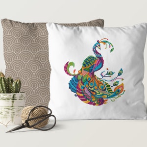 May include: A white cushion featuring an embroidered peacock design. The peacock is depicted in a stylised, geometric pattern with vibrant colours, including blue, green, yellow, orange, pink, and purple.