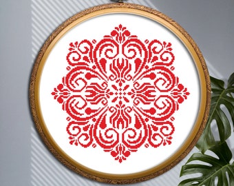 May include: Red and white cross-stitch embroidery design of a floral mandala pattern in a round wooden frame.