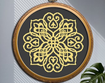 May include: A gold-colored mandala design embroidered on black fabric, framed in a wooden hoop.