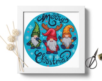 May include: A blue circular design with the text "Merry Christmas" and three gnomes. The gnomes are wearing green, red, and orange hats. The gnome in the red hat has antlers.