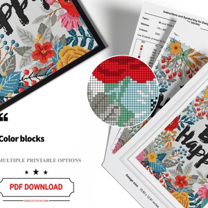 May include: A cross stitch pattern featuring a floral design with the text "Be Happy" in black. The pattern is in a white frame and includes a colour key and instructions.