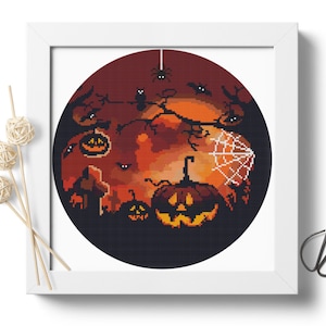 May include: A round cross-stitch pattern featuring a spooky Halloween scene with a large orange pumpkin, smaller pumpkins, bats, a spider web, and a dark red moon.