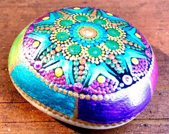 Bright colorful mandala dot painted rock in metallic colors.
