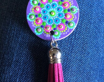 Necklace hand painted with mandala design in lavender, turquoise, pink, green with crystals added for sparkle.