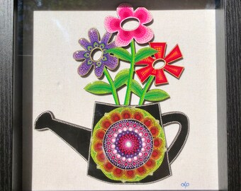 Hand painted watering can with flowers on wood and framed in a shadow box frame with glass