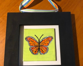 Butterfly on canvas with black frame