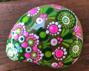 Pink and green dot painted mandala rock in bright spring colors.