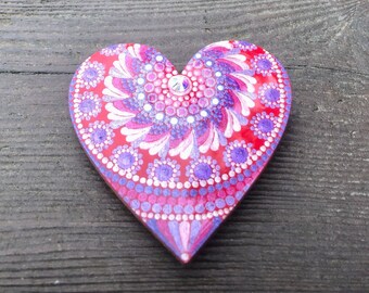 Heart shaped magnet hand painted in mandala design in Red,pink and purple dots and swooshes on wood.