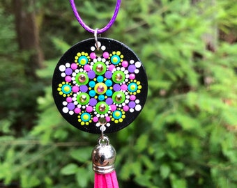 Hand painted wooden mandala necklace with tassel on a cord.