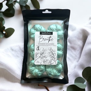 May include: A package of six green shower steamers with the text "Breathe Shower Steamers Eucalyptus & Peppermint essential oil + menthol" and "Kechi Bath Company" on the front. The package is labeled "Box (230g)".