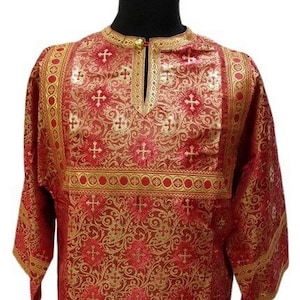 May include: A red and gold liturgical robe with a cross pattern. The robe has a high neckline and long sleeves.
