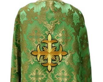 May include: Green liturgical vestment with a gold embroidered cross on the back. The fabric has a brocade pattern with gold accents.