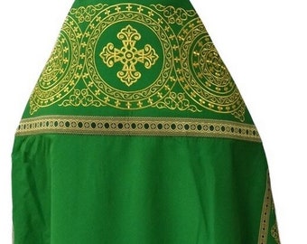 May include: Green liturgical vestment with gold embroidery. The embroidery features a cross and intricate patterns.