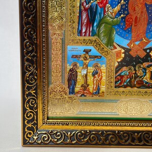 May include: Ornate religious icon featuring a detailed depiction of biblical scenes. The artwork is framed in a dark brown and gold decorative frame. The icon includes figures in vibrant colors, with gold accents and intricate details.