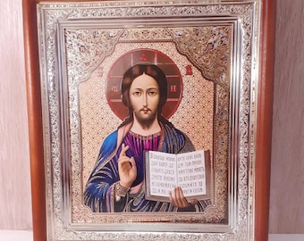 May include: A framed religious icon with a silver border and a gold background. The icon depicts Jesus Christ holding a book with text in Cyrillic script. The text reads "3 спикель мовою БИТE CESE БОЛЬ ЛЮБИТЕ ДРУГА НИКТОЖЕ МІНЯТЬ ДРУГО КЛИОЖЕ ДА ВТОДЕЩЕТ СВОИ ПРУГИ СВОМ".