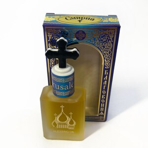 May include: A square glass bottle of Blessing Oil with a black cross-shaped stopper. The bottle has a gold label with church domes. The box is blue with gold accents and Cyrillic text.