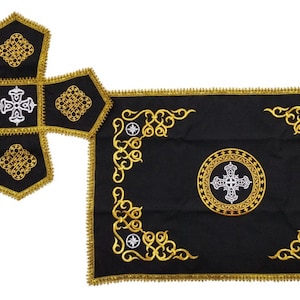 May include: A black altar cloth with gold embroidery and a white cross in a circle. A matching black and gold cross is also included.