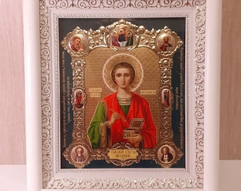 Icon in wooden white frame of Martyr Panteleimon Healer | Icon under glass with decoration | Orthodox icon | Lithography icon | 21x24 cm |