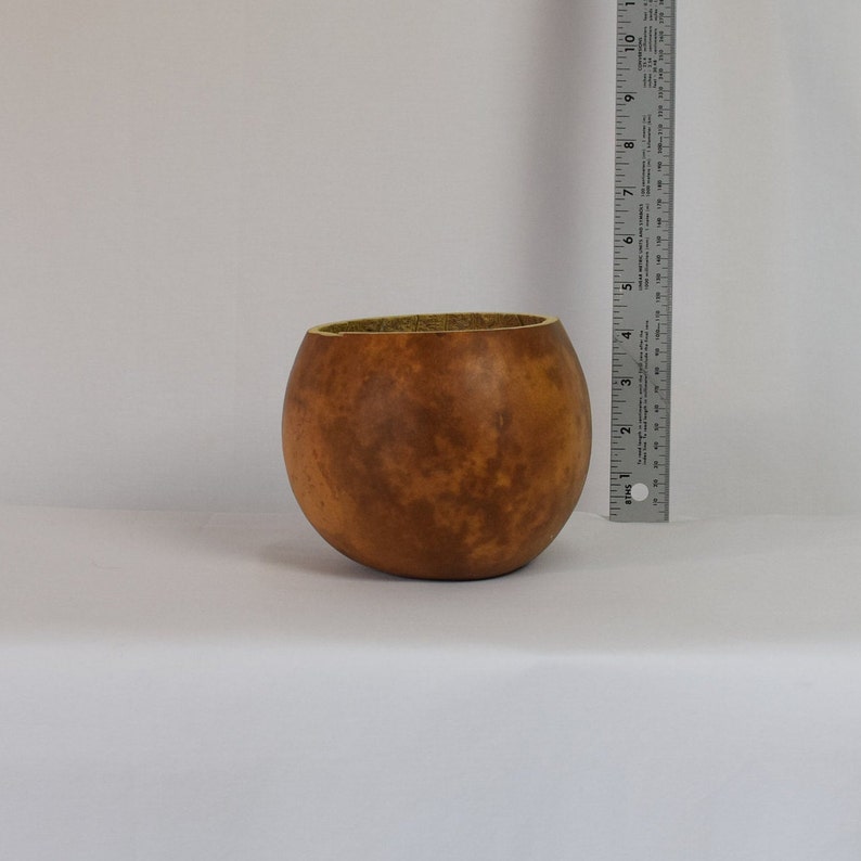 This is a straight cut bowl made from dried hard shell gourds that is 6 inches in diameter.