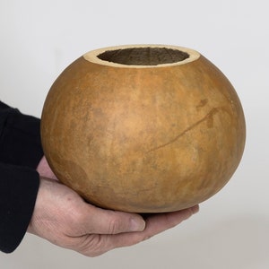 Example of our 6-inch gourd bowl in hands for size reference.