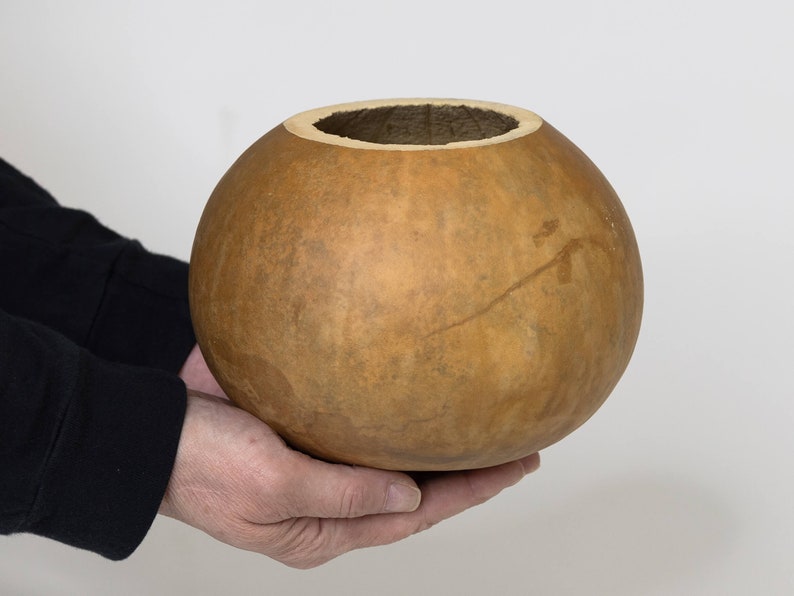Example of our 6-inch gourd bowl in hands for size reference.