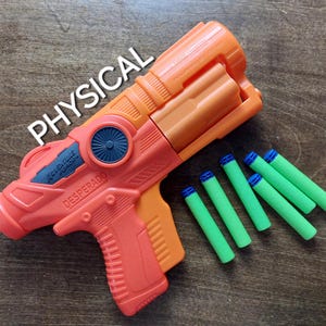 May include: Orange and black toy gun with the words "Valentine Force" and "Desperado" printed on the side. The gun is accompanied by six green and blue foam darts.