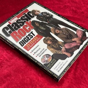 May include: A close-up of the cover of a magazine titled "Classic Rock Digest" featuring a group of musicians. The magazine cover features the text "25 Years of Rock 'n' Roll" and includes a free music CD inside.