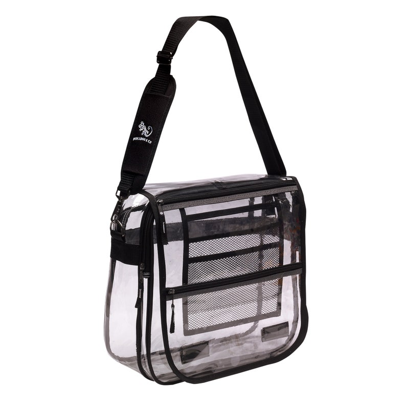 May include: Clear plastic messenger bag with a black adjustable shoulder strap and multiple compartments. The bag has a black zipper and a black mesh pocket. The strap has a small white logo that says "WILD ABOUT YOU CO."