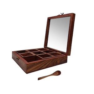May include: A square wooden spice box with a dark brown grain finish, featuring nine internal compartments and a hinged lid with a clear glass panel. A small matching wooden spoon is positioned in front of the open box, which includes a metal latch.