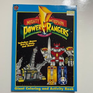May include: A giant coloring and activity book featuring the Mighty Morphin Power Rangers. The cover features the Red Ranger, the Tyrannosaurus Dinozord, and the Yellow Ranger's Zord. The book includes mazes, dot-to-dots, and more.