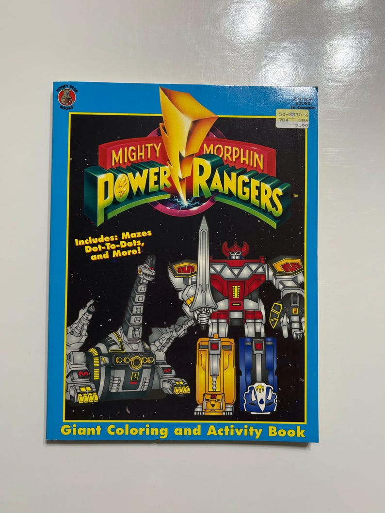 May include: A giant coloring and activity book featuring the Mighty Morphin Power Rangers. The cover features the Red Ranger, the Tyrannosaurus Dinozord, and the Yellow Ranger's Zord. The book includes mazes, dot-to-dots, and more.