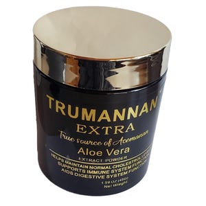 May include: A black jar with a gold lid and label. The label reads "TRUMANNAN EXTRA True source of Acemanan Aloe Vera EXTRACT POWDER" and lists the benefits of the product. The jar contains 1.59 oz (45g) of powder.