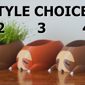 May include: Five different styles of sloth-shaped planters, each with a different color. The planters are arranged in a row from left to right, numbered 1 through 5. The planters are all made of a smooth, plastic-like material. The planters are all empty, but they are designed to hold small plants or succulents.