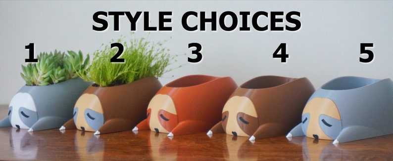 May include: Five different styles of sloth-shaped planters, each with a different color. The planters are arranged in a row from left to right, numbered 1 through 5. The planters are all made of a smooth, plastic-like material. The planters are all empty, but they are designed to hold small plants or succulents.