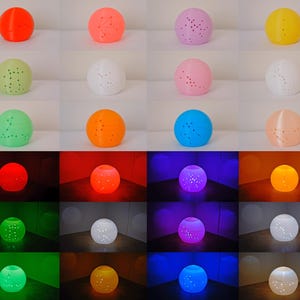 May include: A collection of spherical decorative lamps in various colors, including orange, pink, and green. Each lamp has a constellation pattern of small holes. The bottom row shows the lamps illuminated with different colored lights.