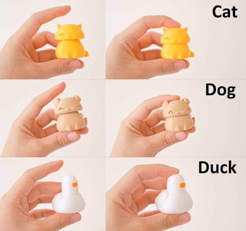 Peut inclure: Trois petites figurines color&eacute;es d'un chat, d'un chien et d'un canard. Le chat est jaune, le chien est brun et le canard est blanc.