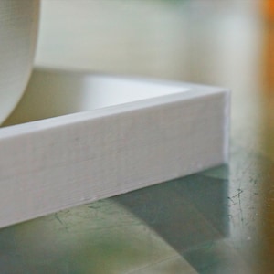 May include: White rectangular planter with a smooth, slightly textured surface. The planter is made of a lightweight material and has a simple, modern design.