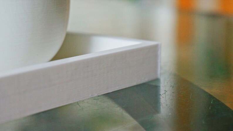 May include: White rectangular planter with a smooth, slightly textured surface. The planter is made of a lightweight material and has a simple, modern design.