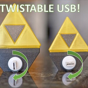 May include: Two gold-colored, 3D printed, triangular USB drives with a black base. The USB port is on the bottom of the base and can be rotated. The text "TWISTABLE USB!" is at the top of the image.