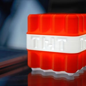 May include: A red and white plastic night light shaped like a block of TNT with the word "TNT" printed on the side.
