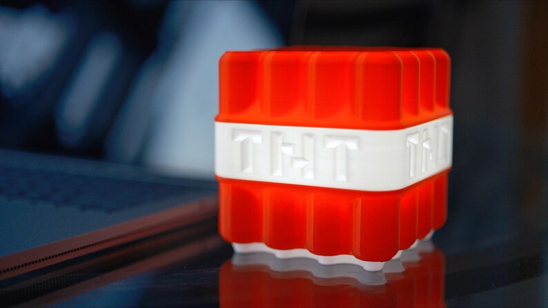 May include: A red and white plastic night light shaped like a block of TNT with the word "TNT" printed on the side.